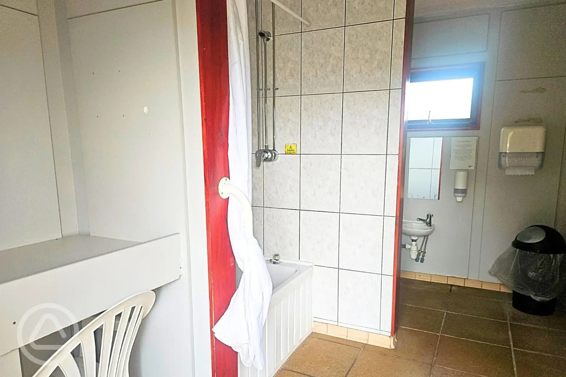 Family bathroom with a toilet, shower and bench area