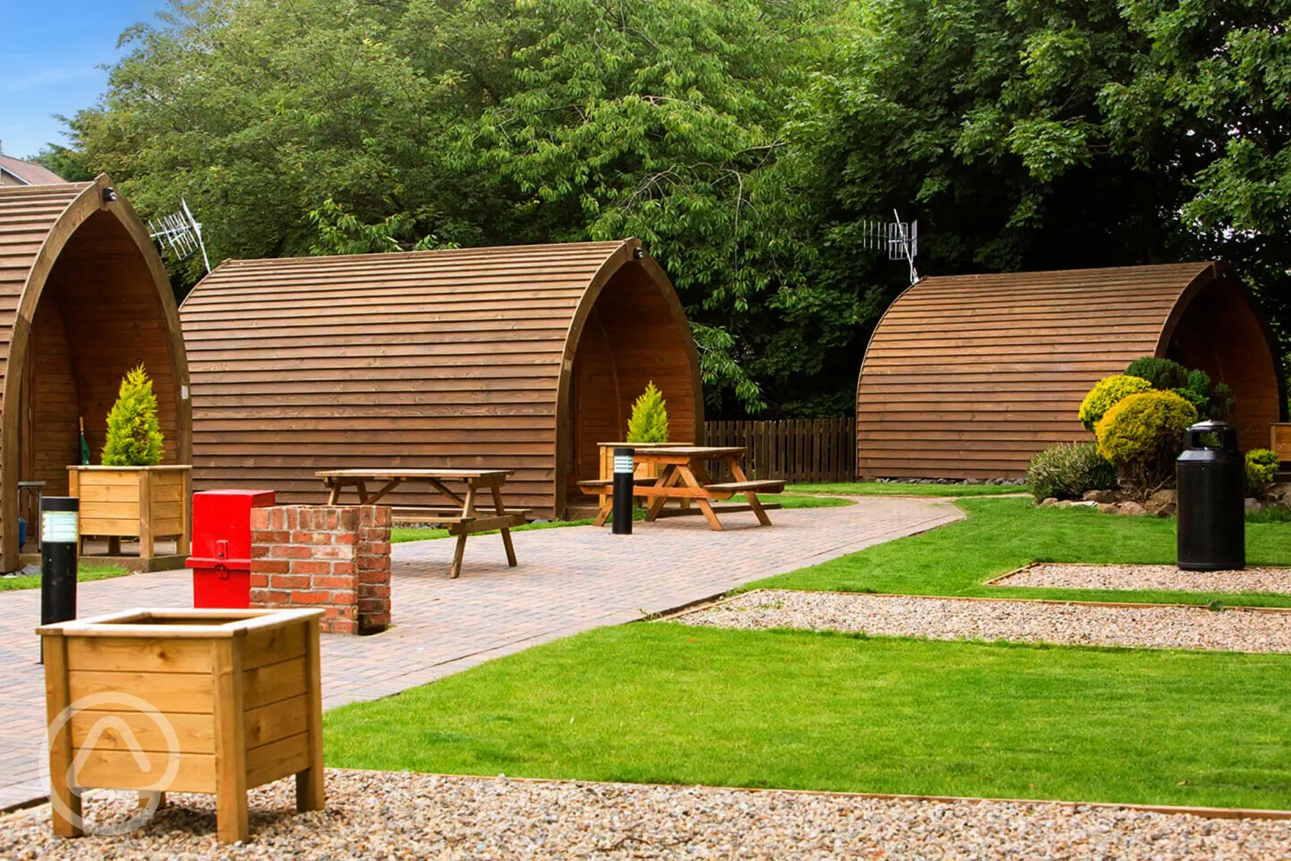 Camping pods with planting and grass areas