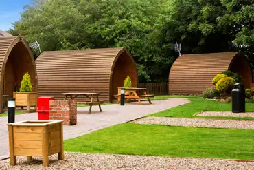 Camping pods with planting and grass areas