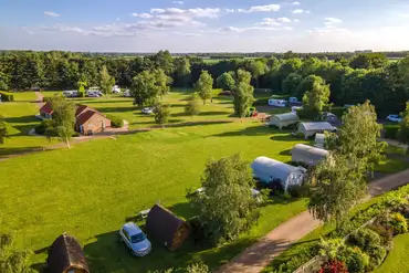 Aerial of the glamping area with views to the central facilities block