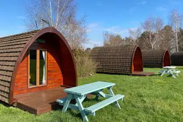 Camping pods with picnic tables and fire pits