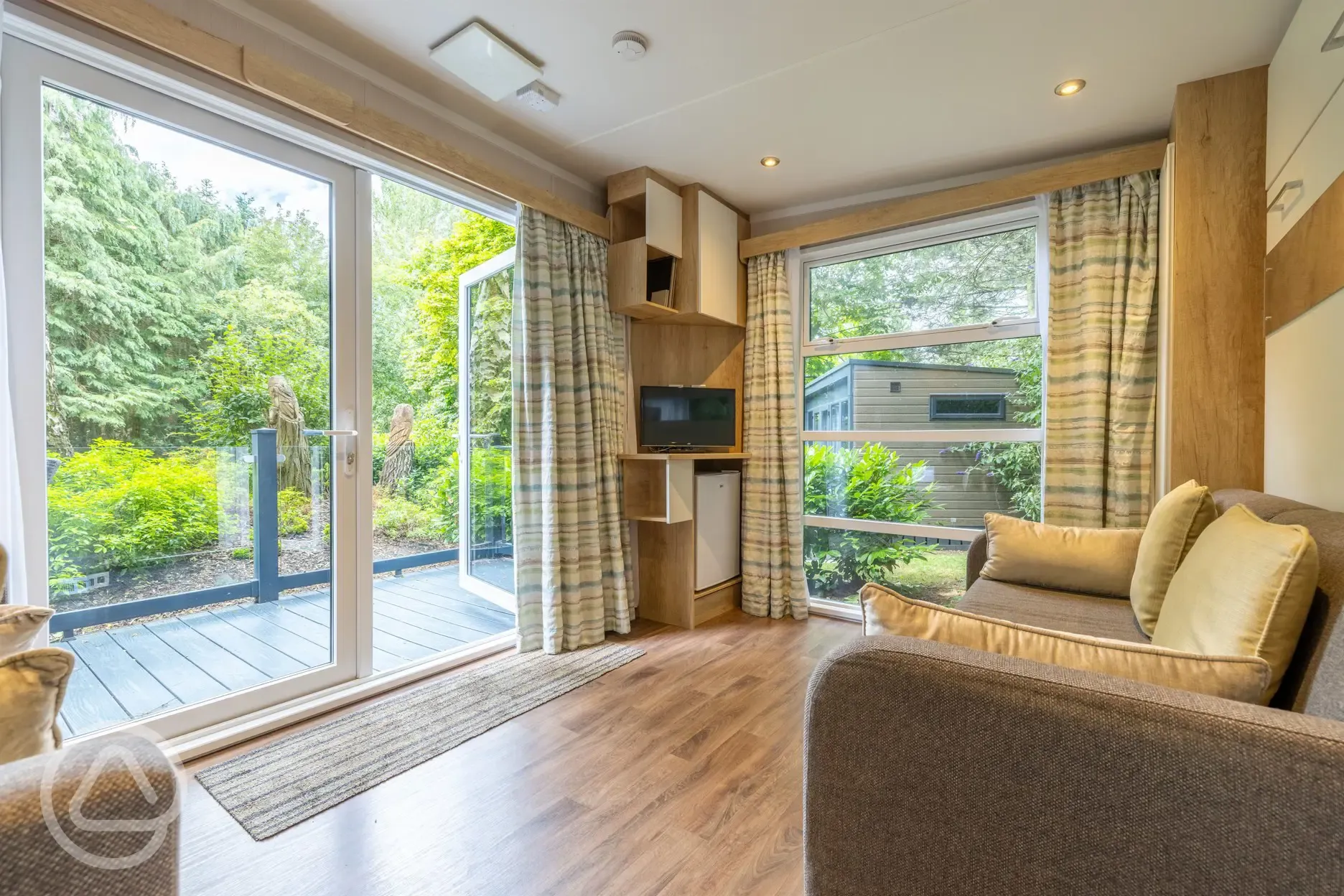 Studio pod cabin living area with a TV and DVD player