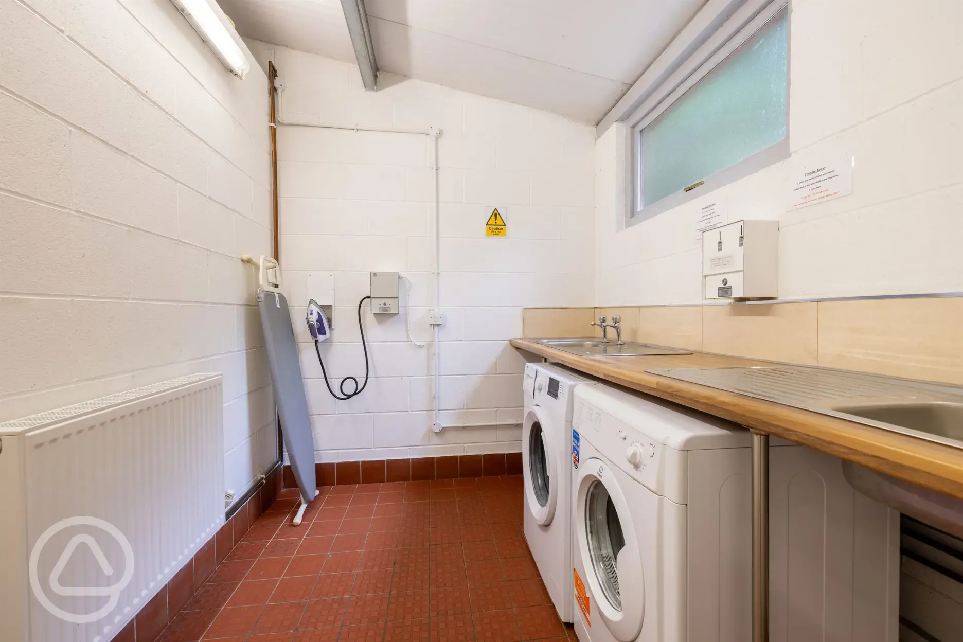 Heated laundry area with washing machine, tumble dryer, iron and ironing board