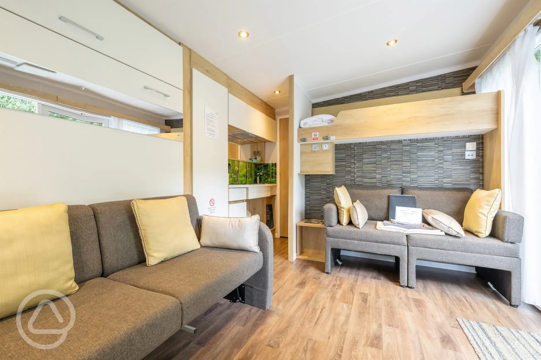 Studio pod cabin living area with double sofa bed and bunkbed