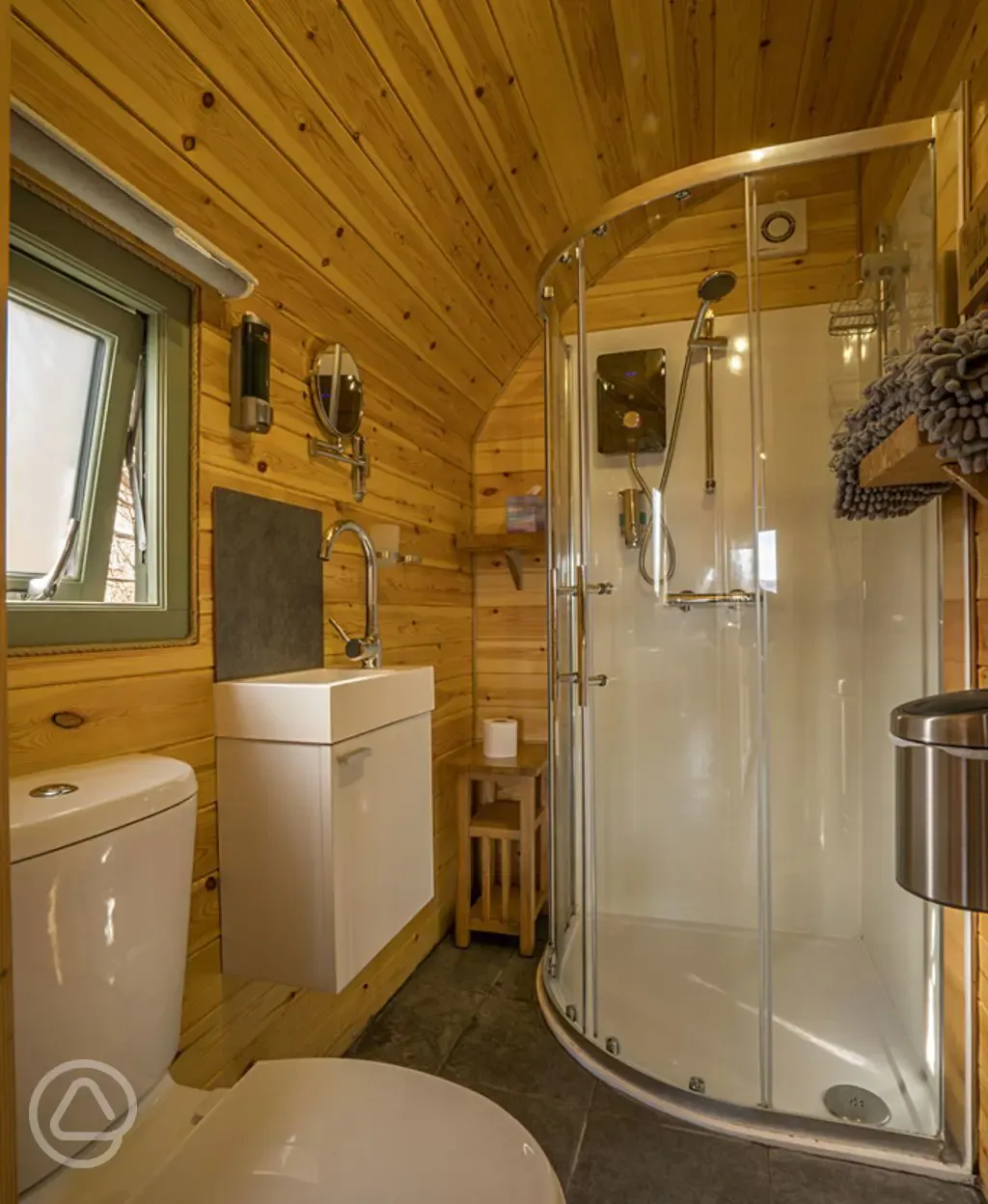 Ensuite bathroom with a hair dryer, towels, and robes provided
