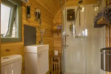 Ensuite bathroom with a hair dryer, towels, and robes provided