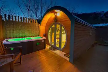 Suilven View ensuite glamping pod at night with decking and hot tub