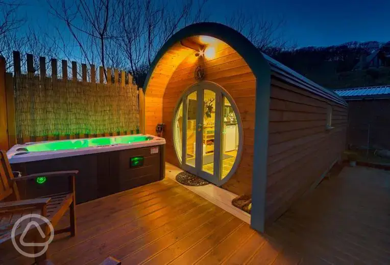 Suilven View ensuite glamping pod at night with decking and hot tub