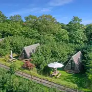 Converted chicken shed pods set amongst cob trees with outdoor seating Converted chicken shed pods set amongst cob trees with outdoor seating