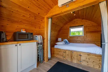 Camping pods with a double bed, kitchen unit and sofa bed