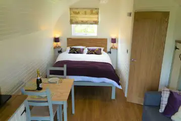 Four persons pod interior with double bed Four persons pod interior with double bed