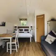 Four persons pod interior with double bed and double sofa bed