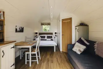 Four persons pod interior with double bed and double sofa bed Four persons pod interior with double bed and double sofa bed