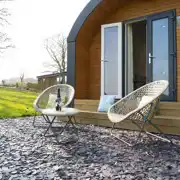 Four person pod outdoor seating and fire pit at Eden Valley Glamping