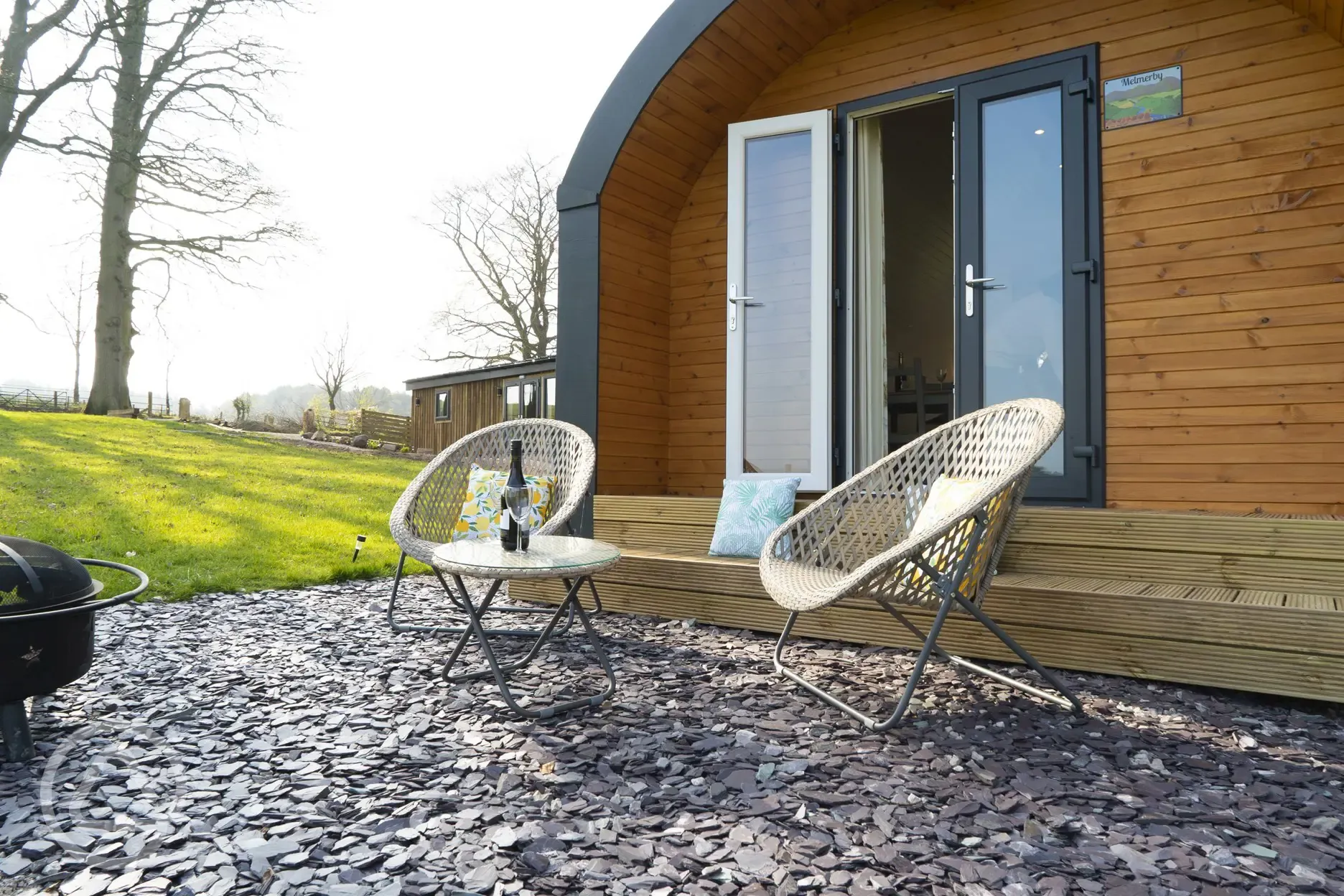Four person pod outdoor seating and fire pit at Eden Valley Glamping