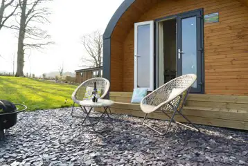 Four person pod outdoor seating and fire pit at Eden Valley Glamping Four person pod outdoor seating and fire pit at Eden Valley Glamping