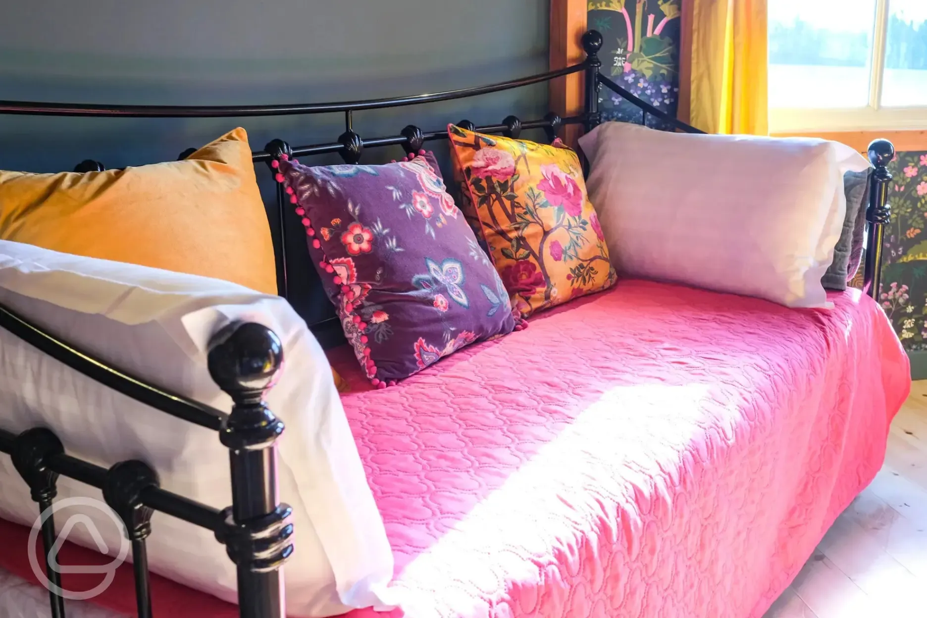 Glamping cabin interior with a day bed that converts to two singles