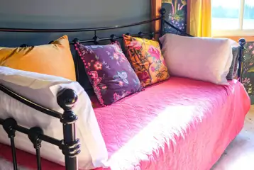 Glamping cabin interior with a day bed that converts to two singles