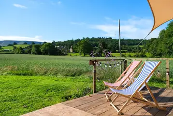 Glamping cabin outdoor deck with tradtional deck chairs