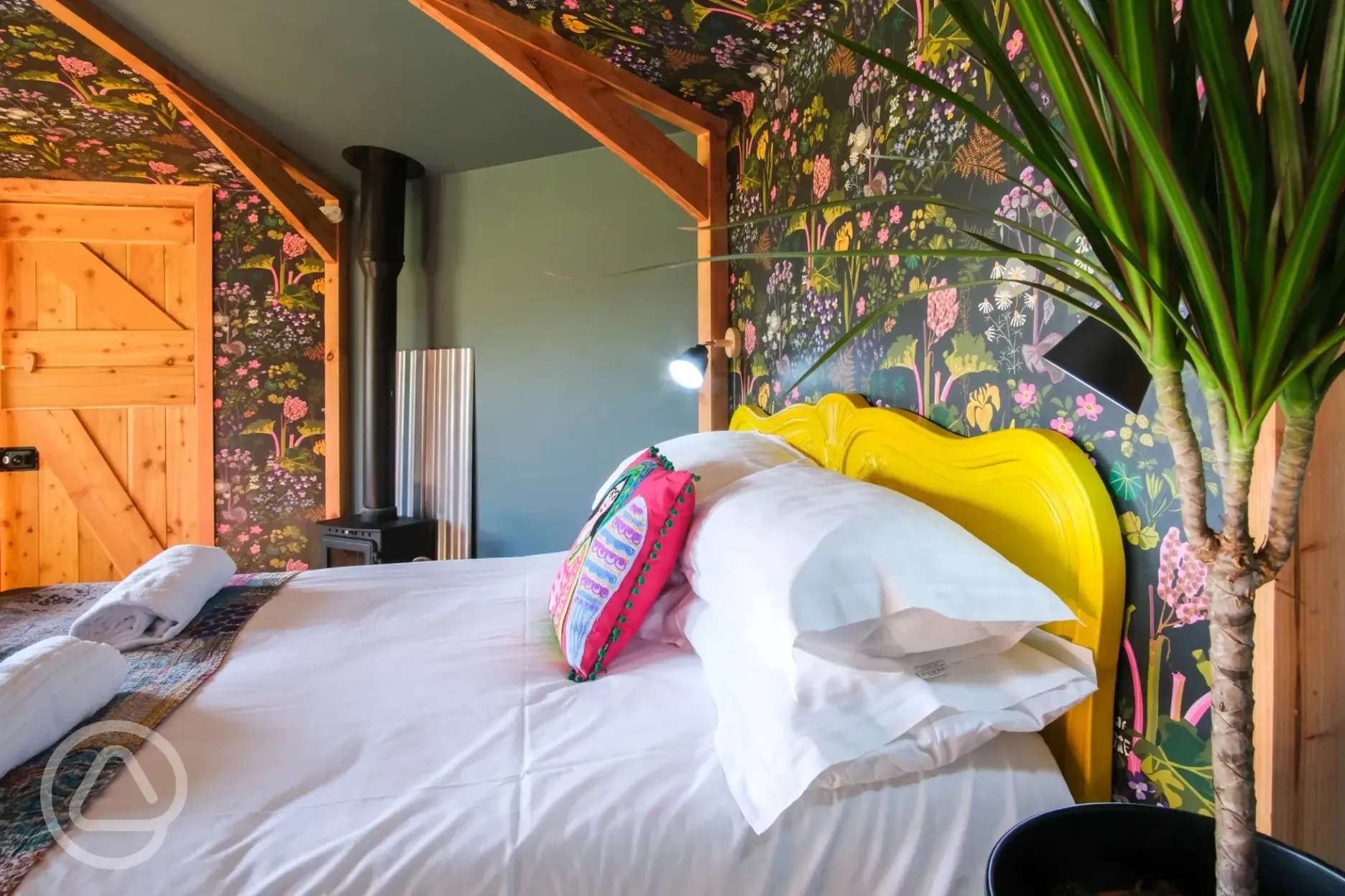 Glamping cabin with a double bed and soft furnishings