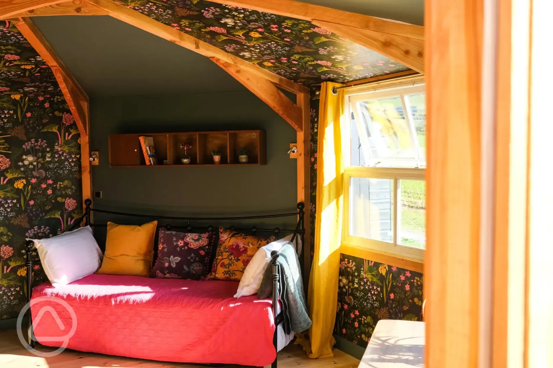 Glamping cabin interior with a day bed that converts to two singles