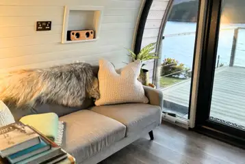 Sildvik and Sunset ensuite glamping pod interiors with a sofa Sildvik and Sunset ensuite glamping pod interiors with a sofa