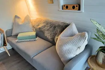 Sildvik and Sunset ensuite glamping pod interiors with a sofa Sildvik and Sunset ensuite glamping pod interiors with a sofa