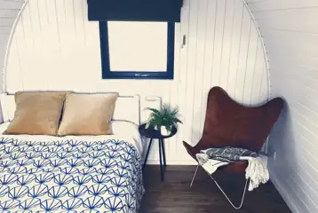 Sea Eagle glamping pod interior with a double bed Sea Eagle glamping pod interior with a double bed
