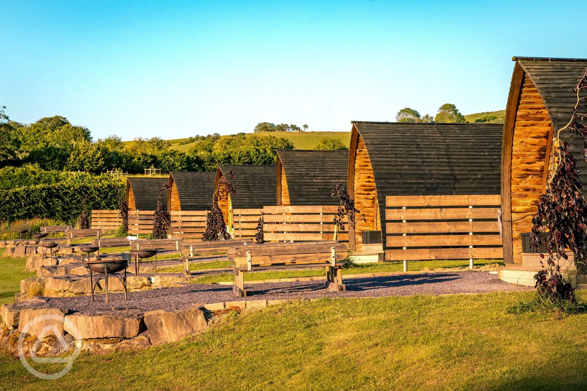 Glamping pods with privacy fencing, fire pits and picnic benches
