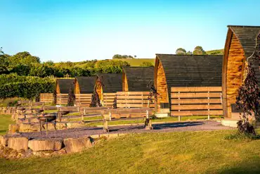 Glamping pods with privacy fencing, fire pits and picnic benches