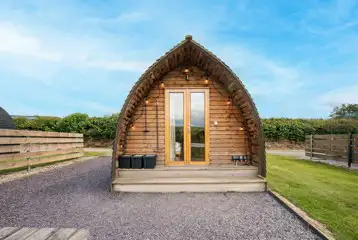 Glamping pod with outdoor lighting and double doors