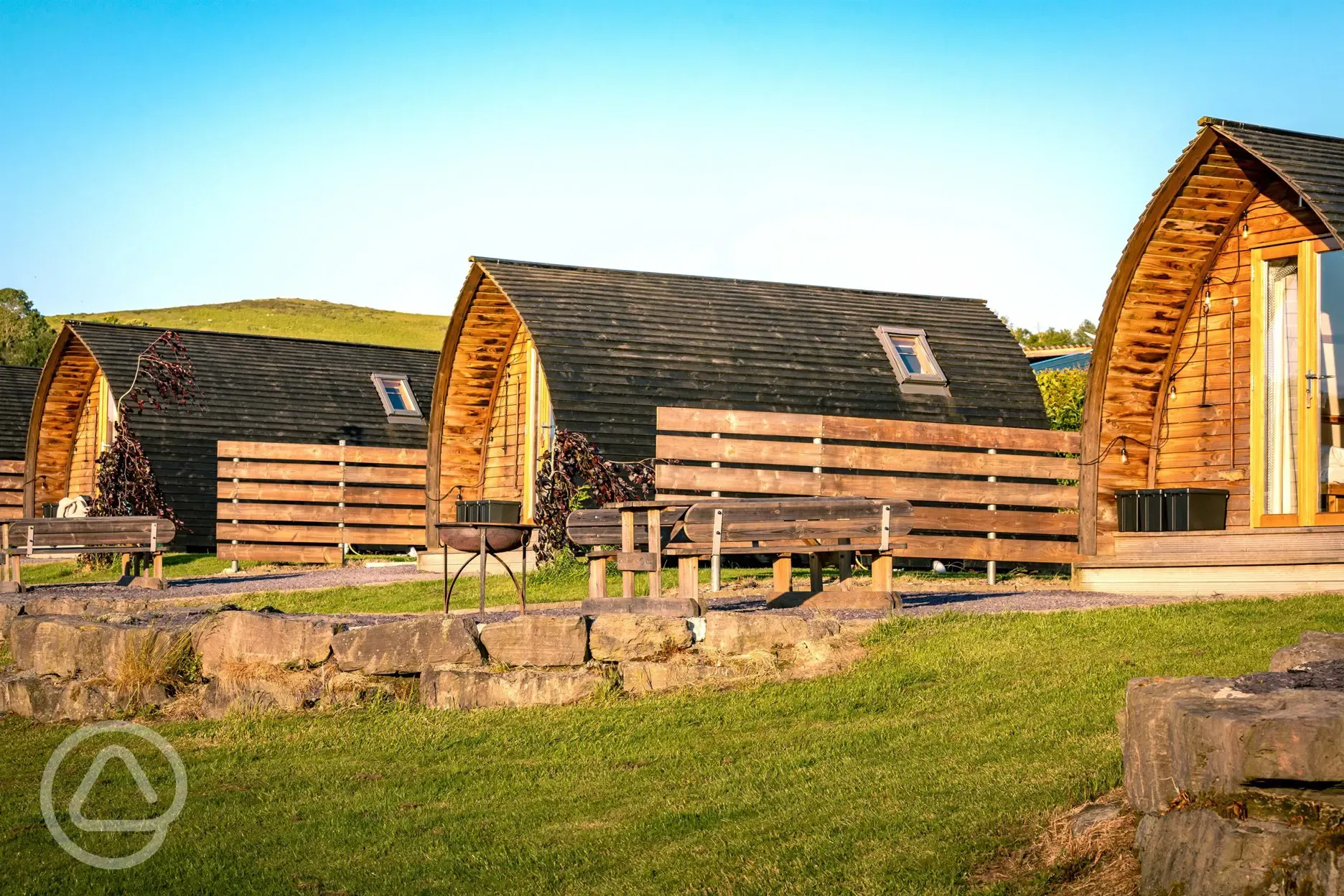 Glamping pods with privacy fencing, fire pits and picnic benches