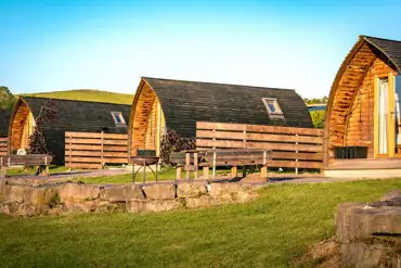 Glamping pods with privacy fencing, fire pits and picnic benches