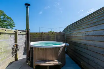Llys y Llwynogod wood-fired hot tub with a fenced surrounding Llys y Llwynogod wood-fired hot tub with a fenced surrounding