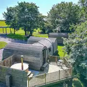 Llys y Llwynogod five person pod with an outdoor deck and hot tub