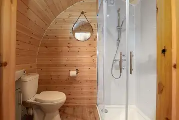 Llys y Llwynogod ensuite bathroom with a toilet, shower and hand basin Llys y Llwynogod ensuite bathroom with a toilet, shower and hand basin