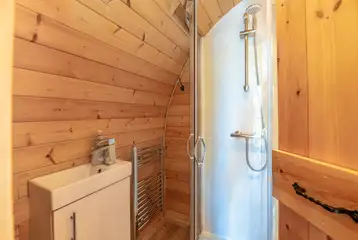 Four person pod ensuite bathroom with a toilet, shower and hand basin Four person pod ensuite bathroom with a toilet, shower and hand basin