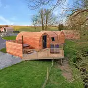 Llys y Llwynogod pod (sleeping five) with a sheltered wood-fired hot tub