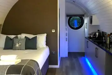 Glamping pod interior with strip LED lighting Glamping pod interior with strip LED lighting