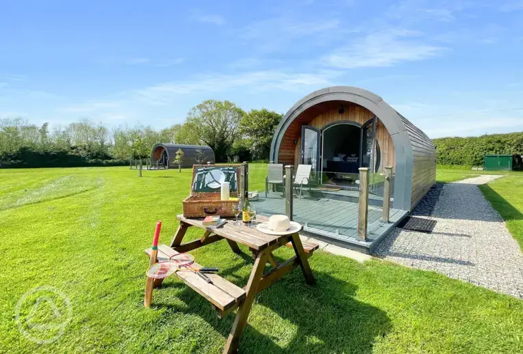 Pods with benches and private deckings at Millview Meadow Glamping