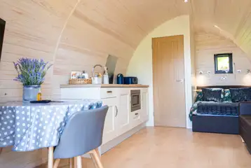 Large glamping pod double bed, dining area and kitchen Large glamping pod double bed, dining area and kitchen