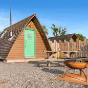 Camping with a private outdoor space with seating, a table and fire pit