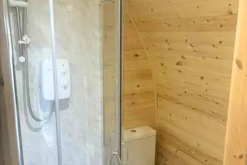 Luxury pod ensuite with a toilet, hand basin and shower