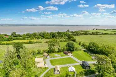 Aerial of the glamping pods with the Solway Coast behind