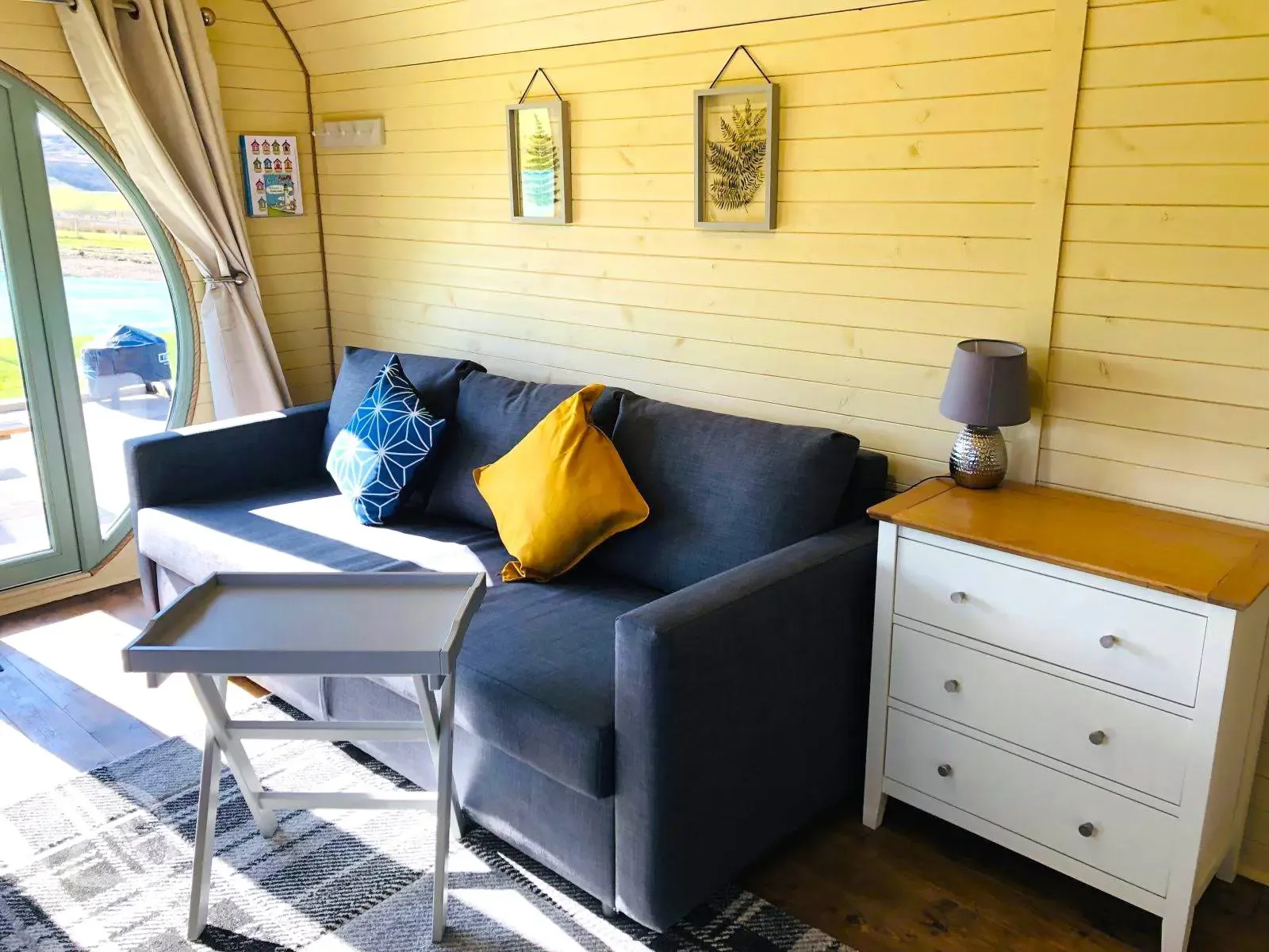Family glamping pod interior with sofa