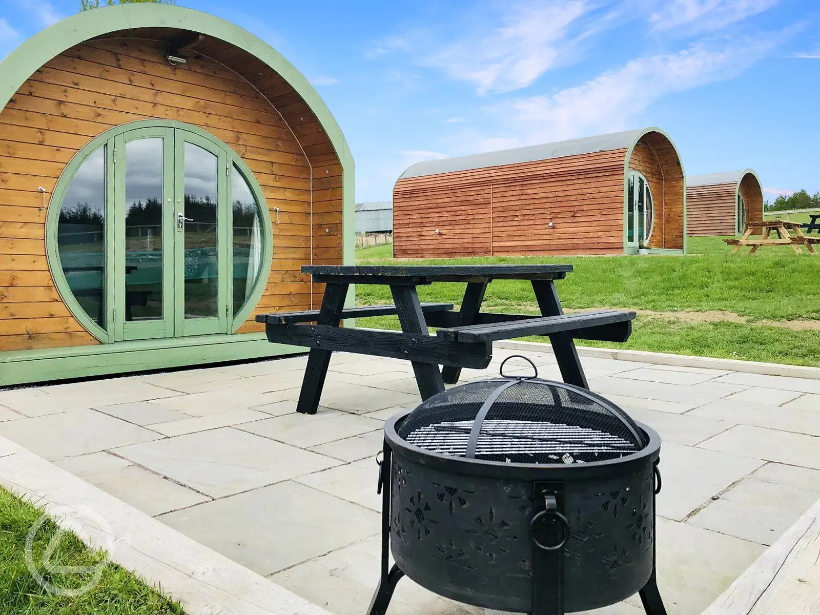 Glamping pods decking area with seating and BBQ