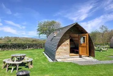 Camping pod with a picnic bench and fire pit