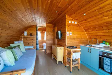 Glamping pod with a sofa, TV and kitchen