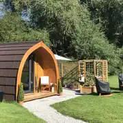 Willow glamping pod with a pergola seating area, fire pit and hot tub
