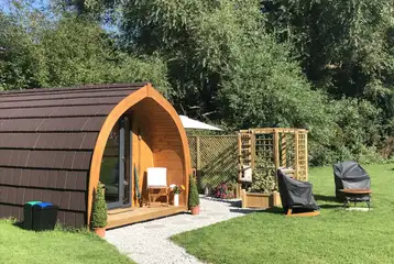 Willow glamping pod with a pergola seating area, fire pit and hot tub